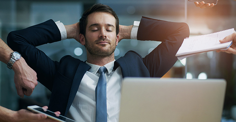 business man at desk looking relaxed